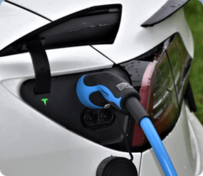 an electric car charging at a charge station