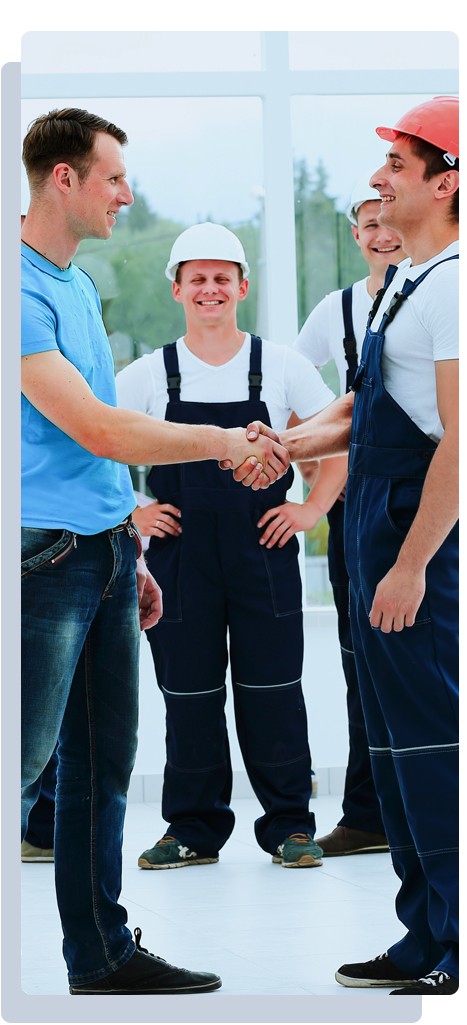 happy homeowner shaking hands of the contractor and team